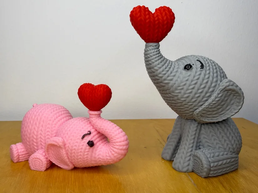 3D printed knitted-style elephant models holding hearts for Valentine's Day