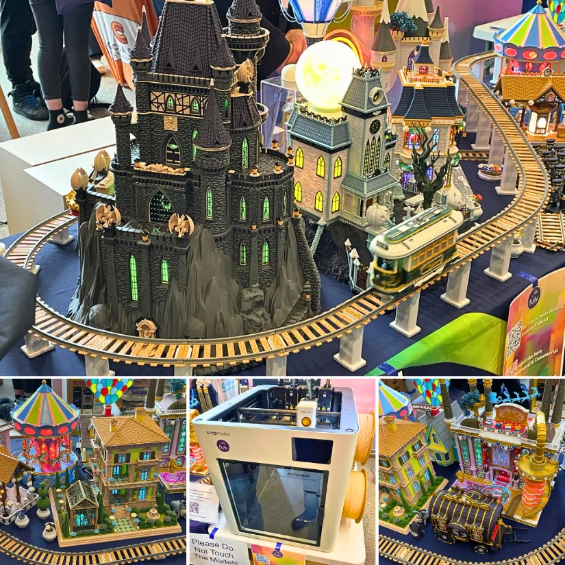 Snapmaker U1 3D printer and Fulv Fairytale Land plus the Tram display at SMRRF 2026 showing detailed miniature buildings, train tracks, and colorful printed models