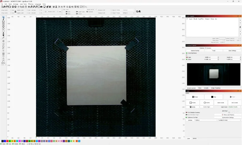 Screenshot of Lightburn software interface featuring a square object centered on a grid. Four clamps secure the object at each corner. Several panels display tools like zoom, pan, measurements, camera settings, image properties, and a color palette.