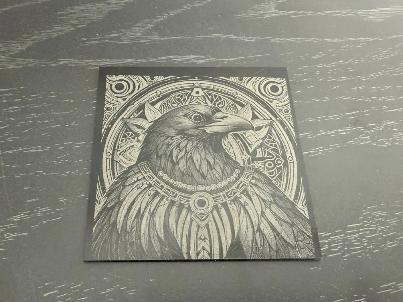 A highly detailed illustration of a raven on acrylic featuring ornate geometric patterns, a decorative bead necklace, and intricate motifs set against a contrasting background.