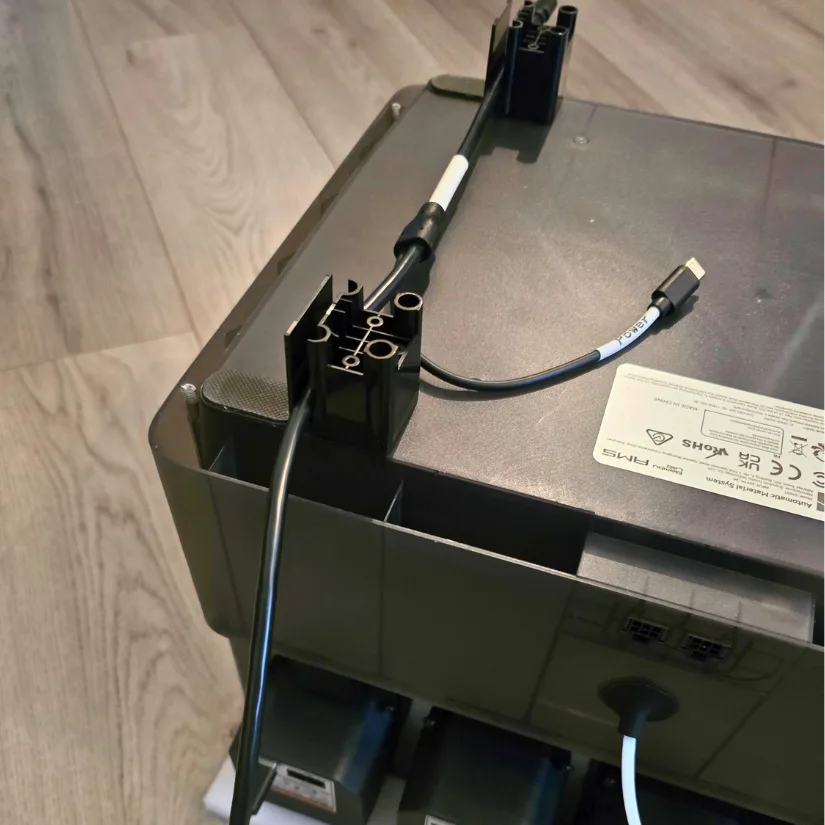 Close-up of support frame mounted to the underside of the AMS unit with USB-C cables labeled and routed through the Tetras dryer assembly.