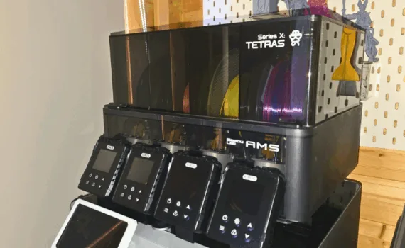 EIBOS Series X Tetras filament dryer attached to Bambu Lab AMS unit with multiple filament spools and screen modules displayed.