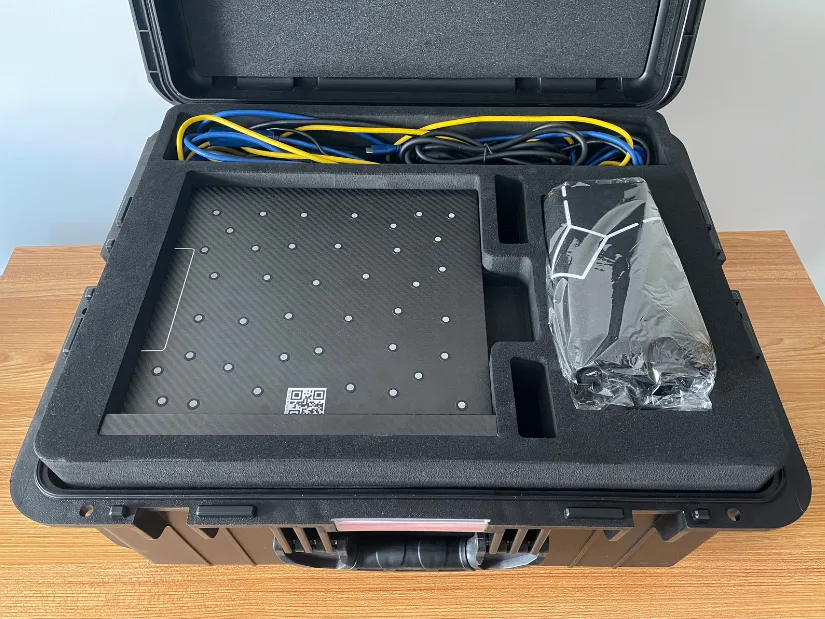 Revopoint Trackit hard case showing calibration board, cables, and accessories neatly packed in foam compartments