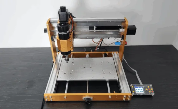 Front view of the Lunyee 3018 Pro Ultra CNC machine with aluminum frame, 500W spindle, and offline controller, positioned on a dark wooden surface.