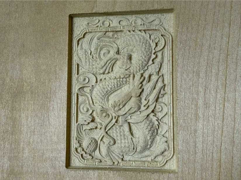Finished dragon relief carved into a poplar board with a 30‑degree V‑bit on the Lunyee 3018 Pro Ultra CNC router, showing crisp fine‑line detail.