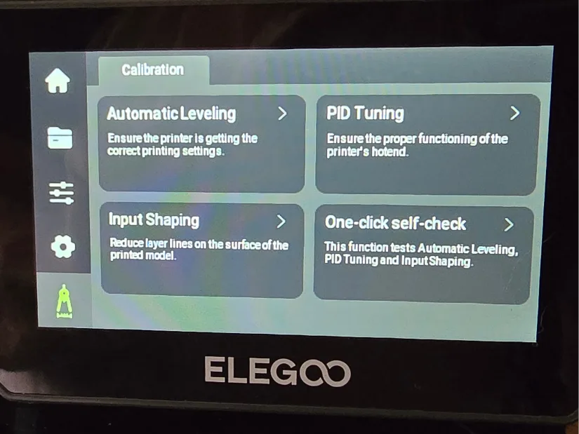 Touchscreen interface on the Elegoo Centauri Carbon showing calibration options including automatic leveling and input shaping