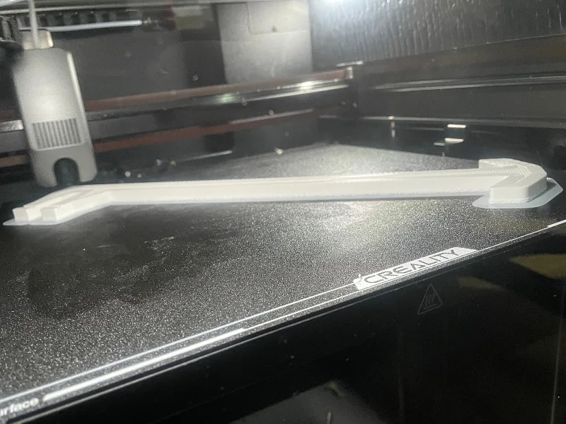 Halfway printed roof window handle in PC-ABS with skirt perimeter for bed adhesion