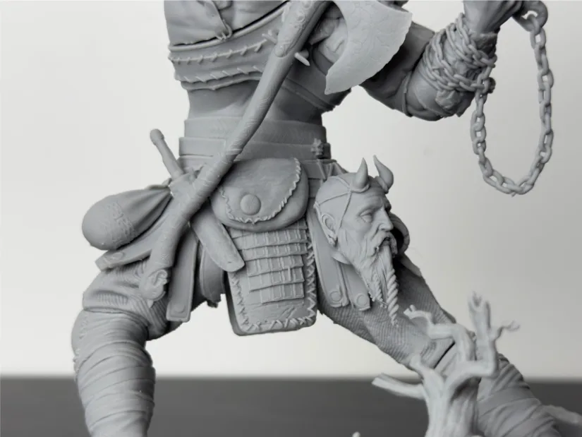 Close-up of Wicked3D Kratos resin print—belt pouches, stitched armor, chain, and trophy head—showing sharp texture detail from the Piocreat HALOT-X1 16K resin 3D printer