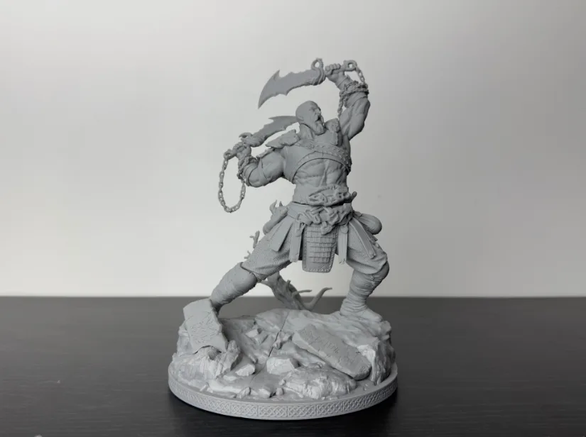 Wicked3D Kratos resin statue, unpainted gray on rocky base—test print from Piocreat HALOT-X1 16K resin 3D printer showing crisp armor, chain, and blade detail