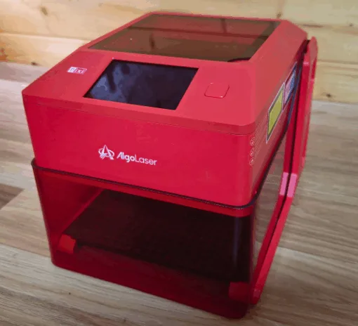 Compact Algolaser Pixi 5W smart laser engraver with enclosure and touchscreen on workbench