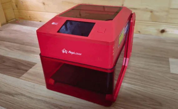 Compact Algolaser Pixi 5W smart laser engraver with enclosure and touchscreen on workbench