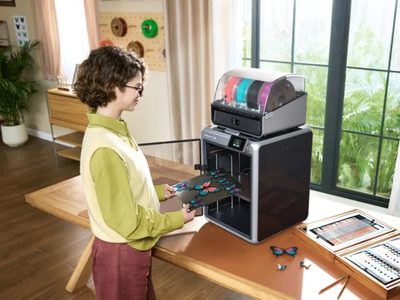 Person Removing Colorful Butterfly Print from Creality K2 3D Printer with CFS