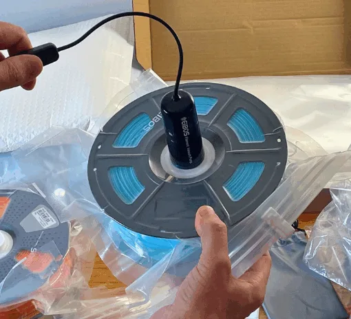 Vacuum sealing a 3D printing filament spool using an electric pump and reusable storage bag