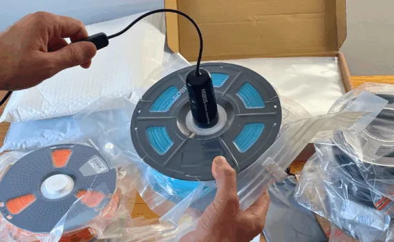 Vacuum sealing a 3D printing filament spool using an electric pump and reusable storage bag