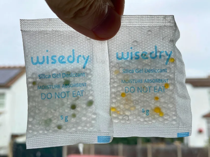Comparison of two Wisedry silica gel desiccant packets showing color change between used and recharged states