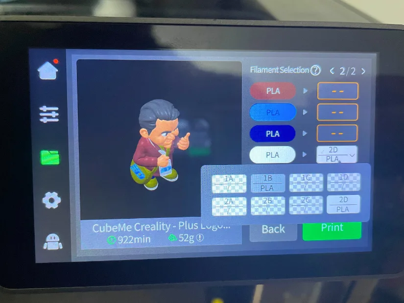 3D model preview on Creality K2 Pro touchscreen showing CubeMe avatar. Filaments assignment in proccess