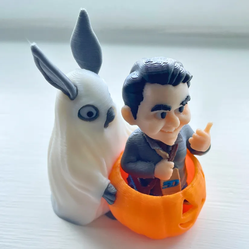 Halloween-themed 3D printed bunny holding a pumpkin with a CubeMe multicolor avatar inside.