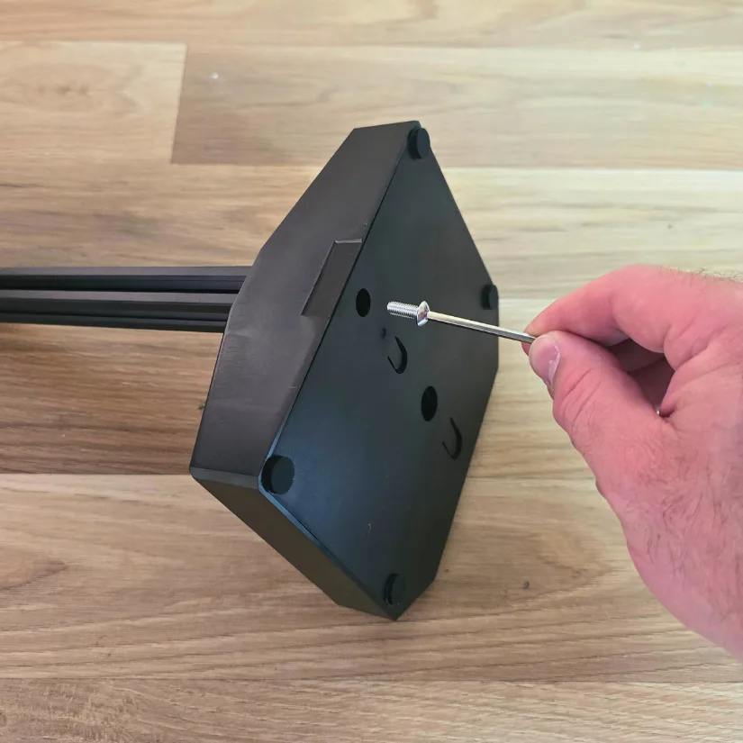 Attaching the extrusion rail to the Mintion Heat Press Kit base using a hex screw