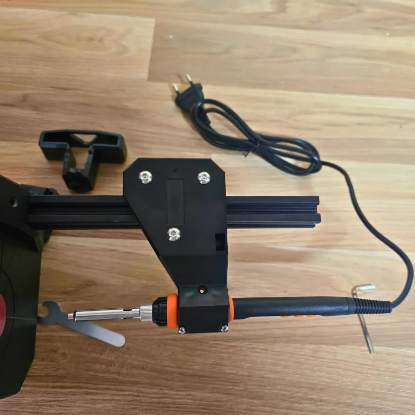 Tightening the Mintion Heat Press heat gun into the clamp with screws