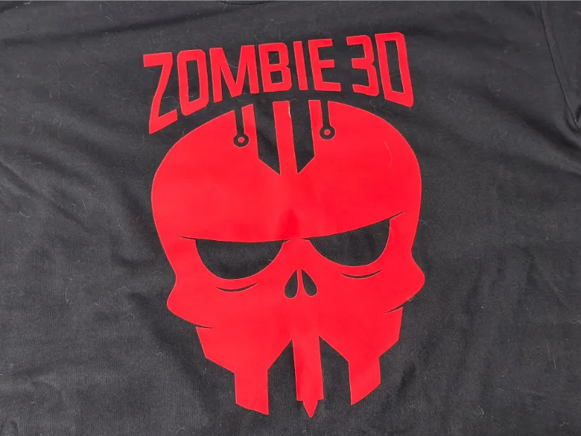 Black T-shirt with a red “StudioZombie 3D” skull graphic applied as a vinyl heat transfer.