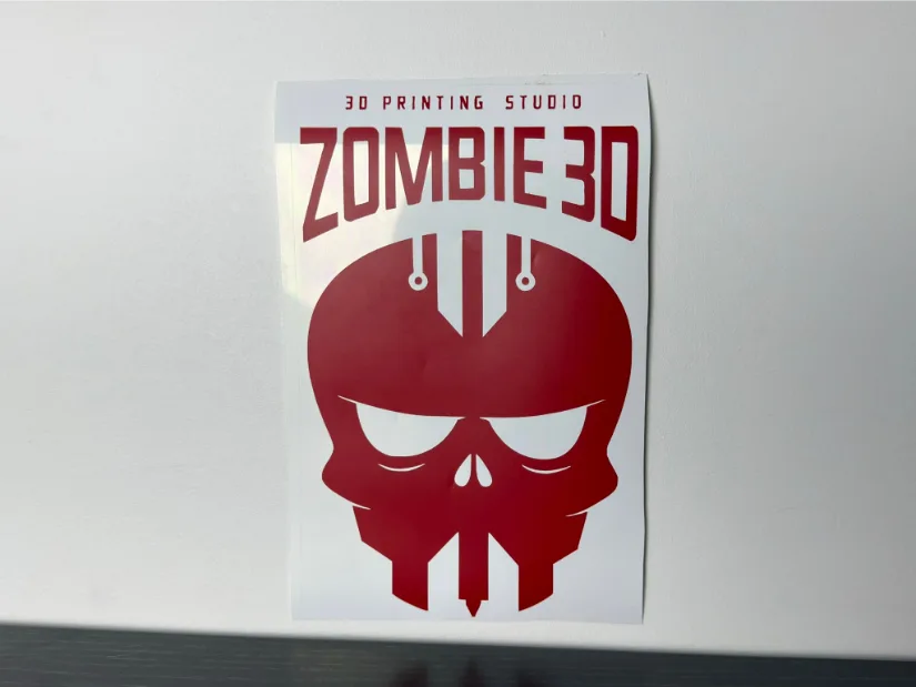 Permanent adhesive vinyl sticker cut with the xTool M1 Ultra, showing a red “ZOMBIE 3D” skull logo on transfer backing.