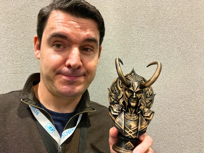 Max Funkner holding a bronze-style 3D printed bust of Loki after attending Comic Con