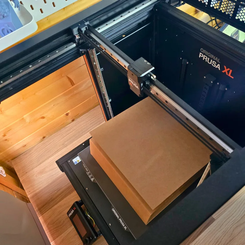 Prusa XL printer setup showing cardboard box on heatbed for safe toolhead and assembly support