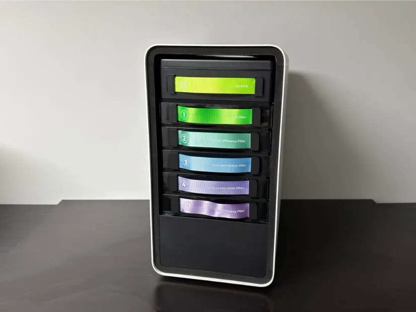 xTool AP2 Air Purifier with the front panel removed, showing the multi-stage filter stack—Cyclone, Pre-filter, Medium Efficiency, Activated Carbon, HEPA/Carbon Mesh, and High Efficiency cartridges.
