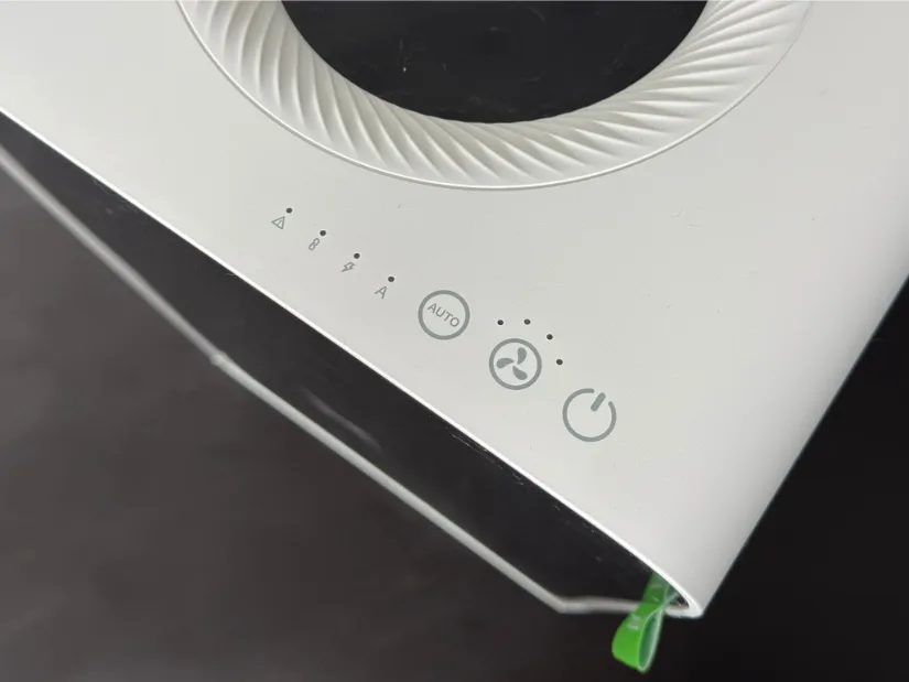 Close-up of the xTool AP2 Air Purifier’s top panel showing indicator LEDs, AUTO mode button, fan-speed button with three dots, and power button around the circular exhaust vent.