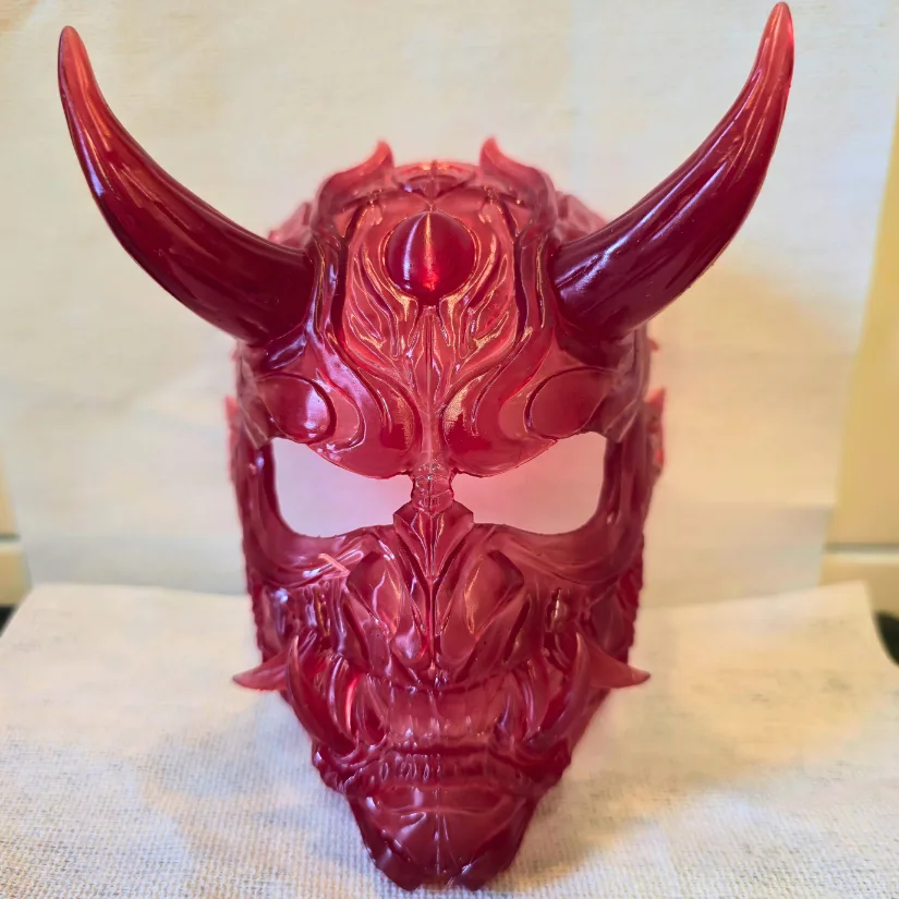 Red transparent resin Oni mask 3D printed on the Uniformation GK3 Pro showing crisp detail