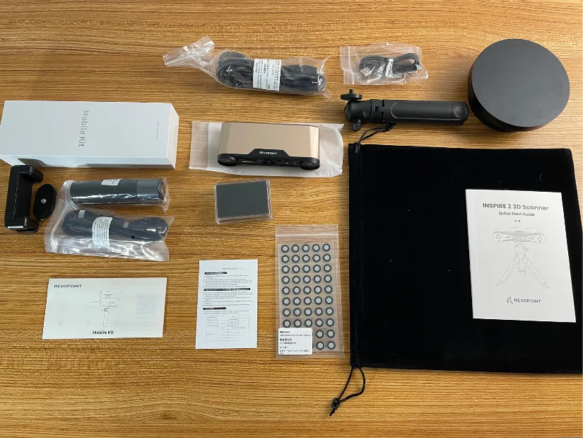 Revopoint Inspire 2 3D scanner unboxed with all accessories including tripod, turntable, mobile kit, cables, markers, and documentation