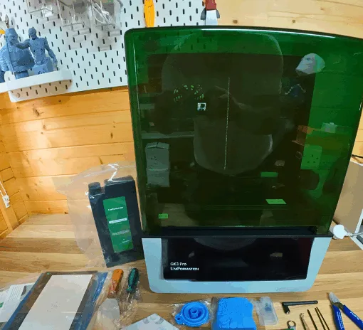 Uniformation GK3 Pro resin 3D printer unboxed with accessories on the workbench