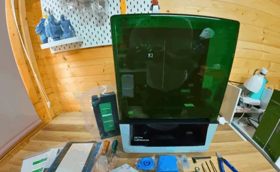Uniformation GK3 Pro resin 3D printer unboxed with accessories on the workbench