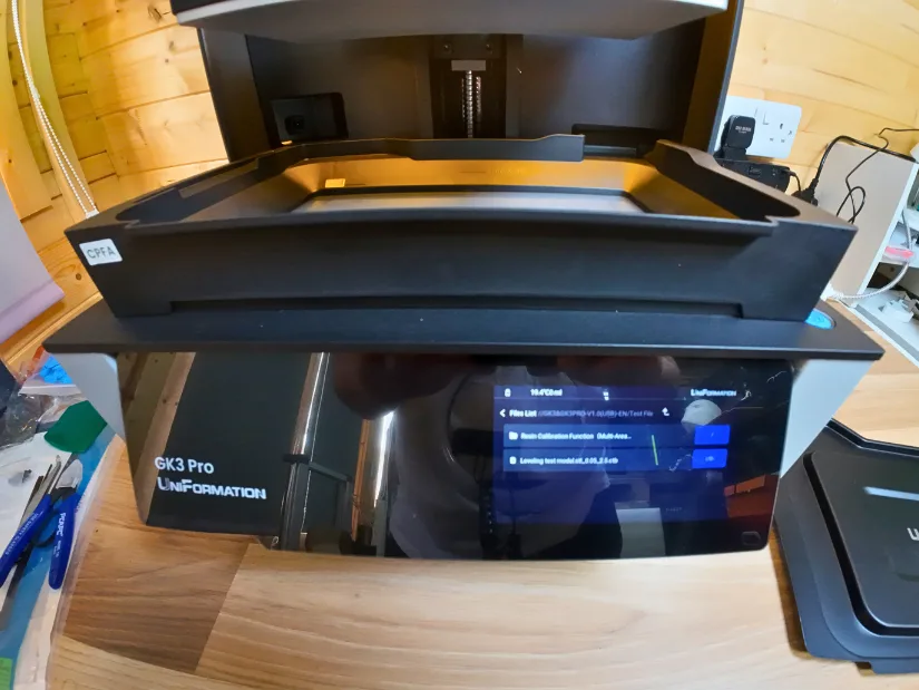 Uniformation GK3 Pro touchscreen interface with the resin vat visible above during calibration