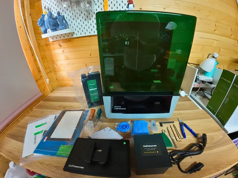 Uniformation GK3 Pro unboxed with all included accessories laid out on the workbench