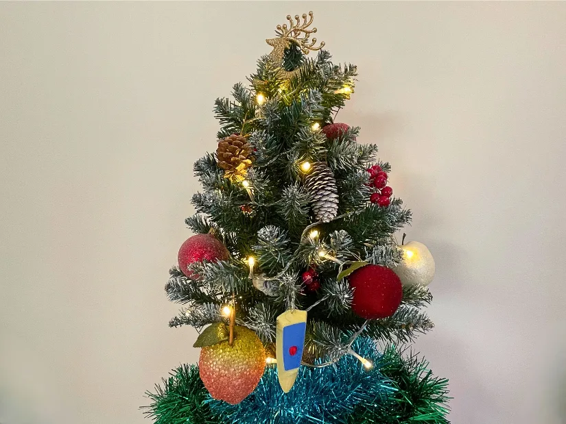 3D printed mini RC boat prototype, scanned with Revopoint INSPIRE 2, hanging as a Christmas tree decoration.