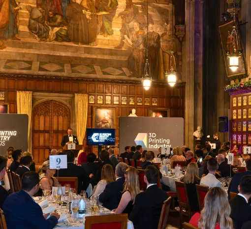 Audience and stage at the 3D Printing Industry Awards 2023 ceremony with attendees seated at tables during the awards presentation