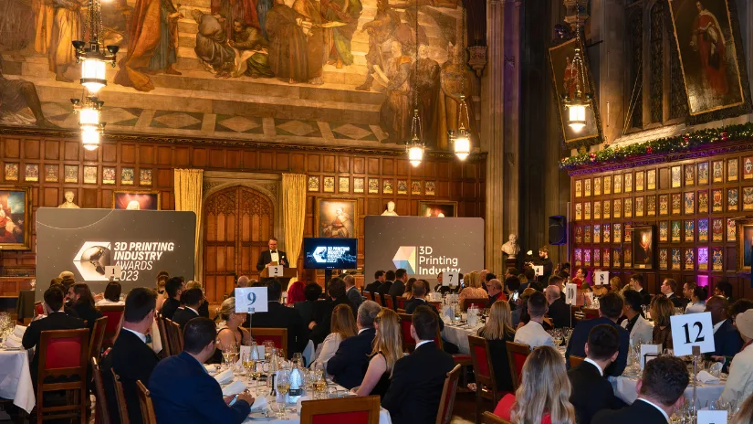 Audience and stage at the 3D Printing Industry Awards 2023 ceremony with attendees seated at tables during the awards presentation