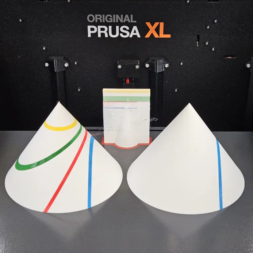 3D printed conic section cones with colored curves shown on a Prusa XL build plate.