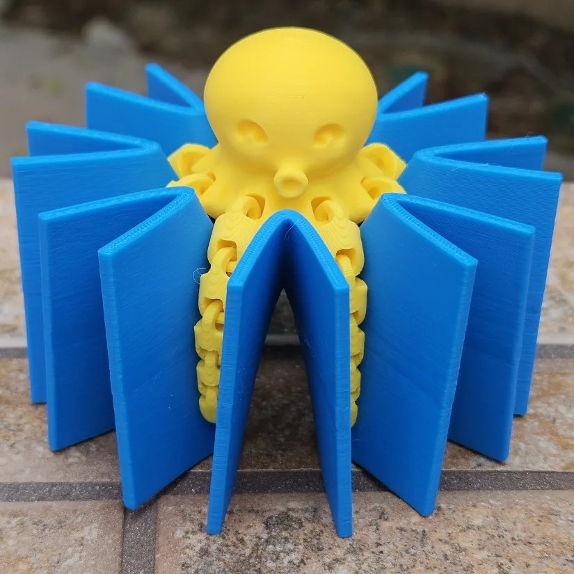 3D printed octopus saddle surface with an articulated octopus figure placed at the center to illustrate higher-order saddle geometry