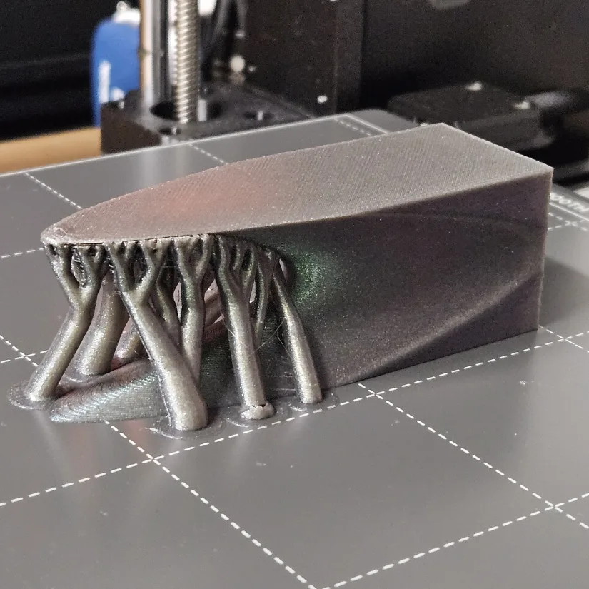 3D printed paraboloid model shown on a build plate with support structures, demonstrating print orientation challenges for complex mathematical surfaces.