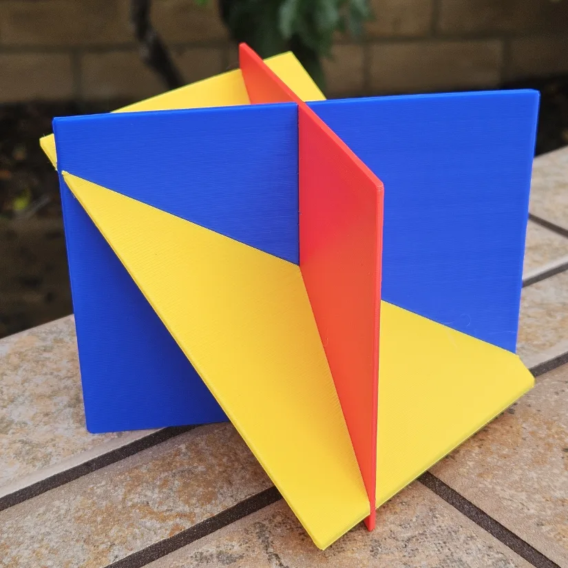 3D printed model showing three colored planes intersecting in space, used to visualize systems of equations in three variables