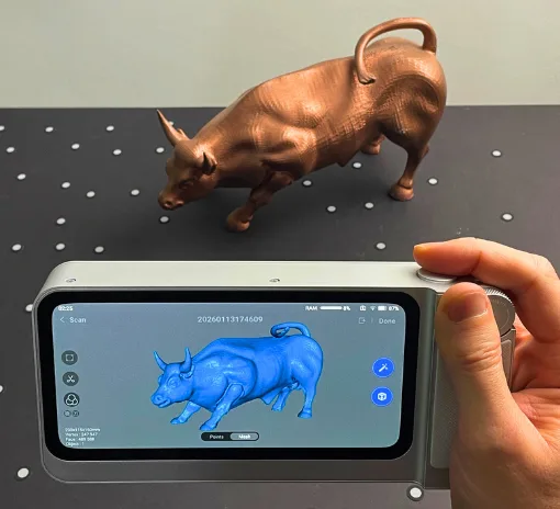 3DMakerpro Toucan handheld 3D scanner capturing a Charging Bull 3D printed model with the scan result shown on the device screen