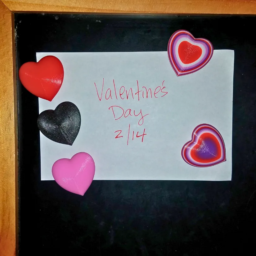 3D printed heart magnets displayed on a board as part of a school Valentine exchange