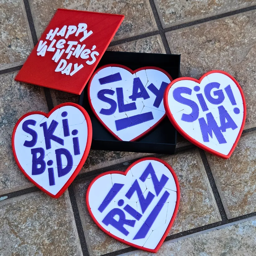 3D printed heart-shaped word puzzles with playful slang messages