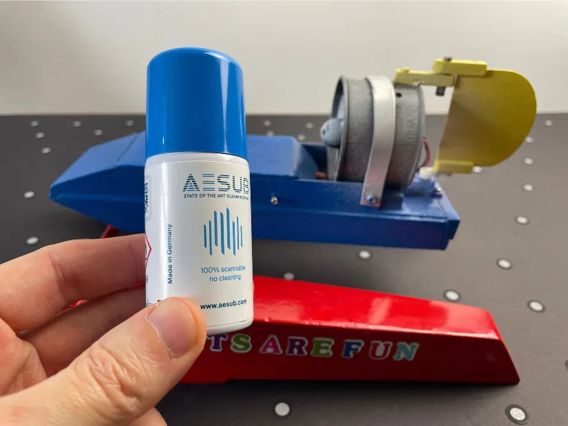 AESUB scanning spray used to matte shiny surfaces before 3D scanning, shown with RC boat model