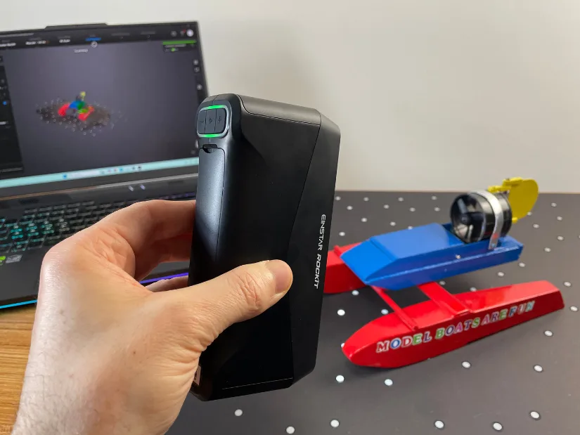 EINSTAR Rockit handheld scanner capturing a small RC boat model with EXStar Hub preview on laptop