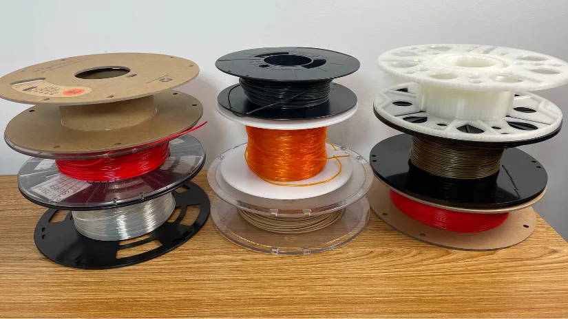 Different cardboard, plastic, refill, and reusable 3D printer filament spool types with varying weights