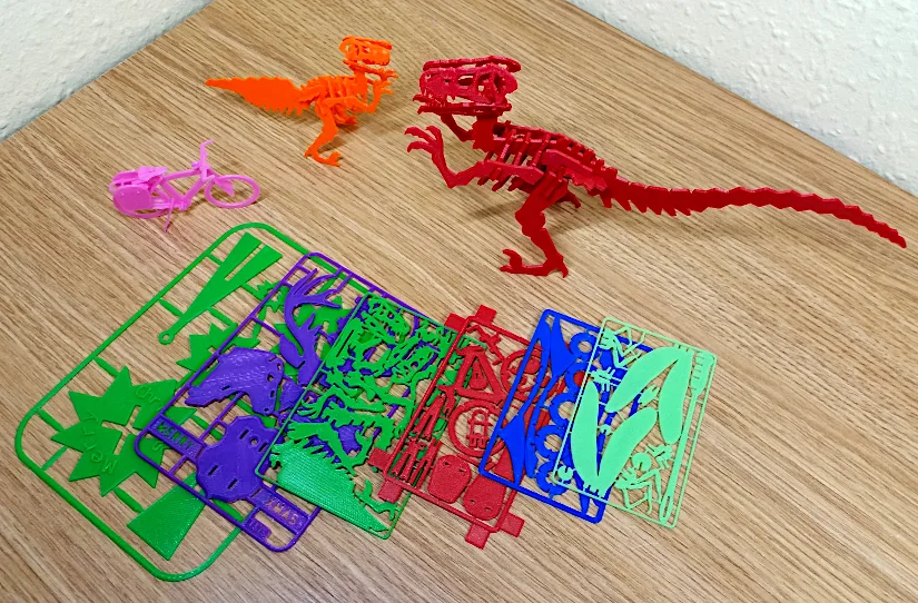 Lightweight 3D printed kit card models and dinosaur skeleton prints made from leftover filament