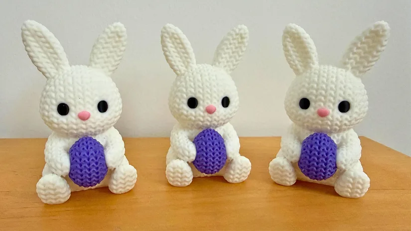 Knitted style designed and 3D printed Easter bunnies holding textured eggs